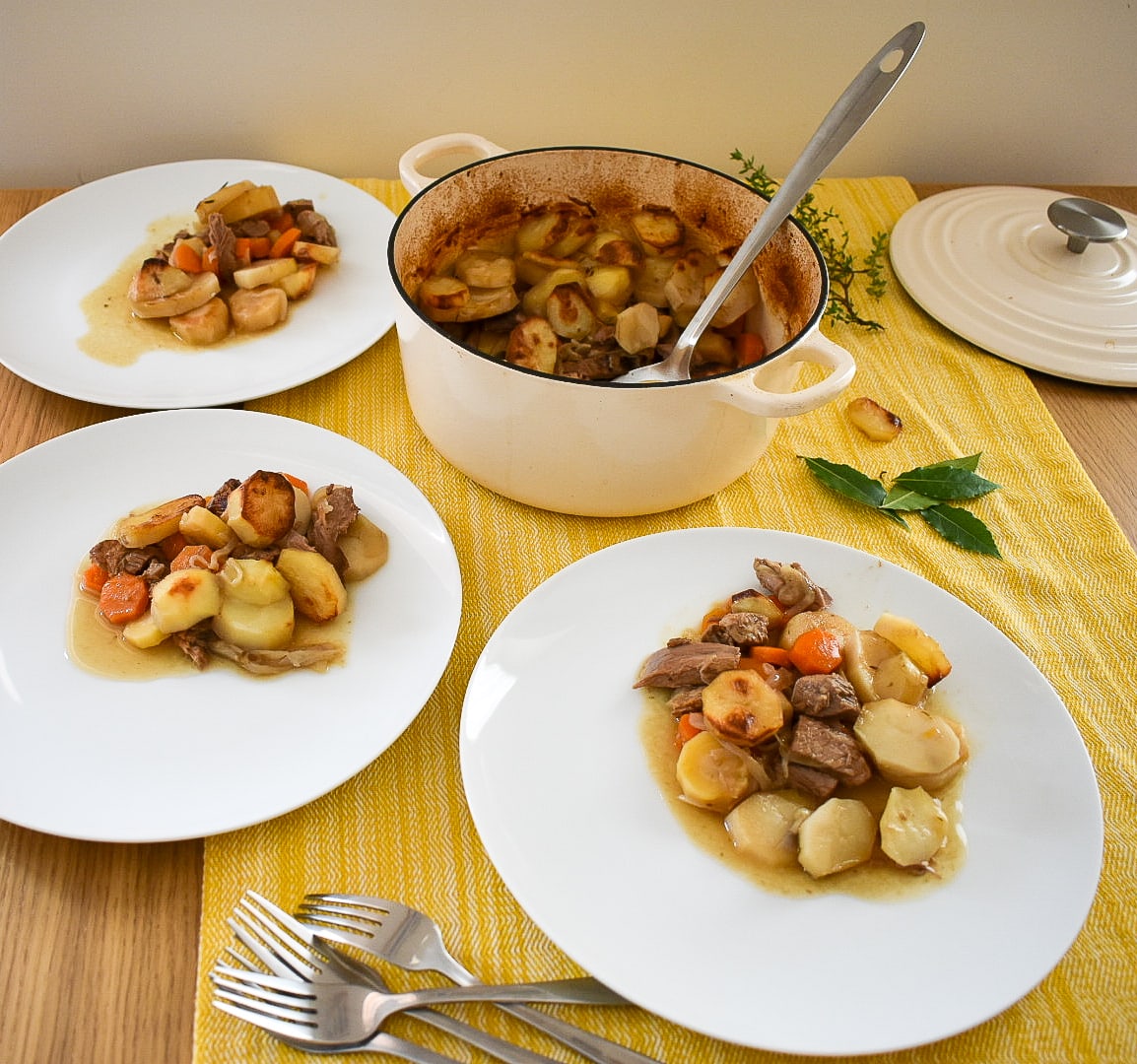 Lamb hotpot being served on table. 