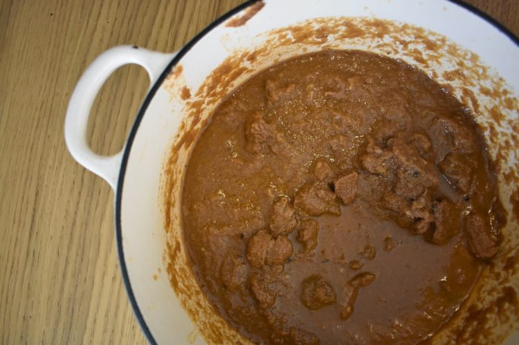 close up of rogan josh cooking in dish