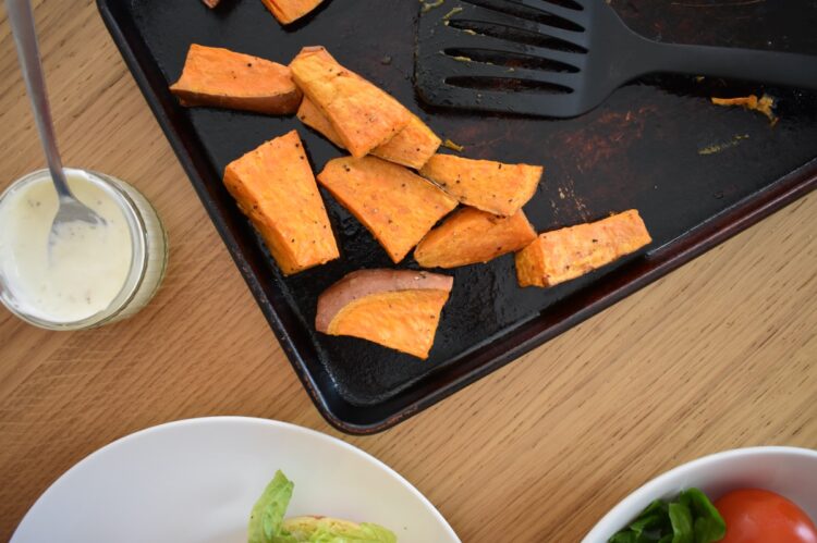 Corner of baking tray with sweet potato wedges
