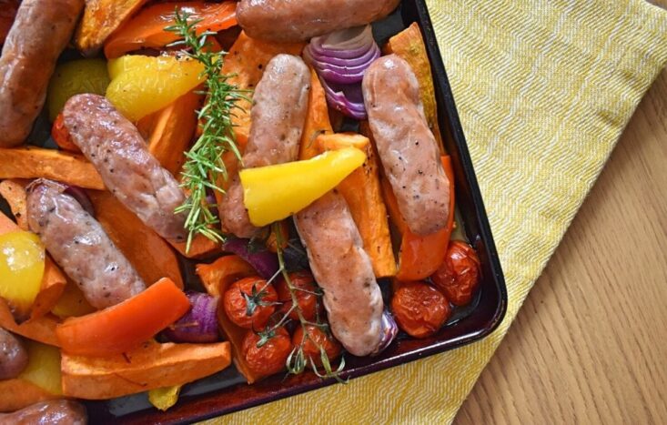 close up of sausage traybake on baking tray