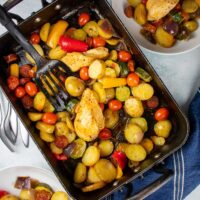 traybake with chorizo and chicken in roasting tin, 2 served portions at the sides
