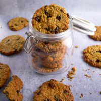 cookies with raisins in jar, 3/4 shot, more cookies on side, scattered around
