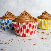 3 coffee cupcakes with mocha buttercream, coffee granules on side