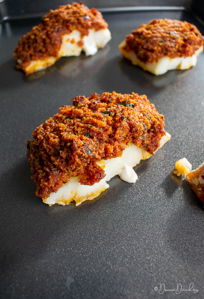 Baked cod on baking tray.
