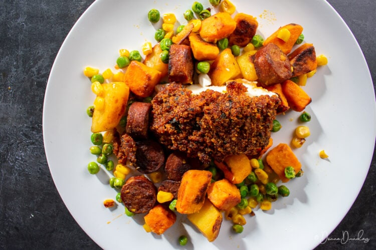 top view of served cod with sweet potato and chorizo hash on plate.