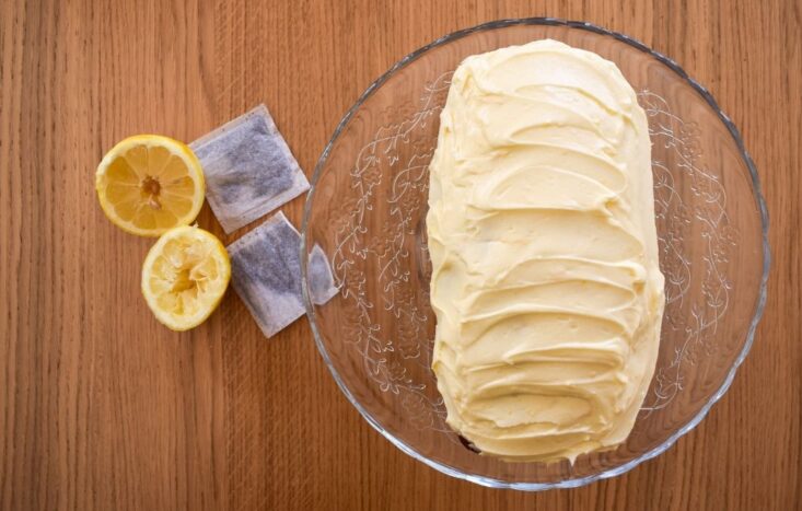 earl grey infused cake with lemon buttercream on glass stand.