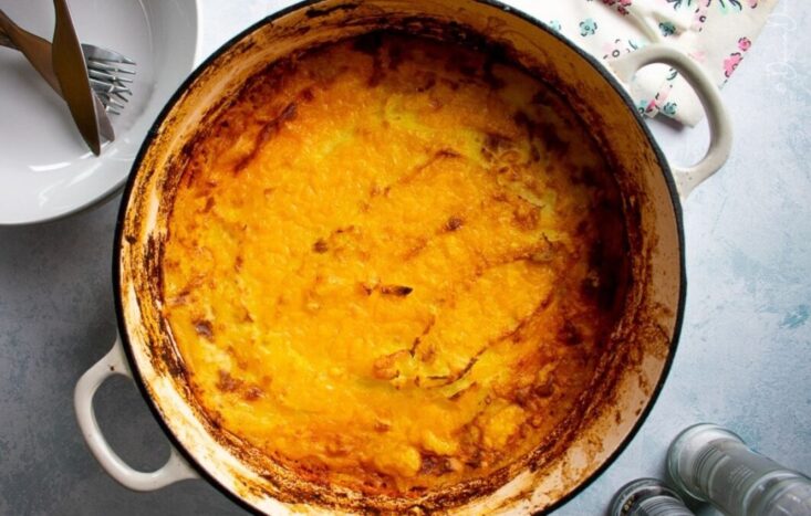 top view of sausage and mash pie in cast iron cooking dish