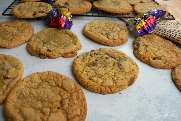 3/4 shot of cookies with wire rack and creme egg wrappers in background.