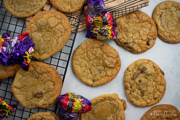 3/4 shot of cookies with wire rack and creme egg wrappers in background.