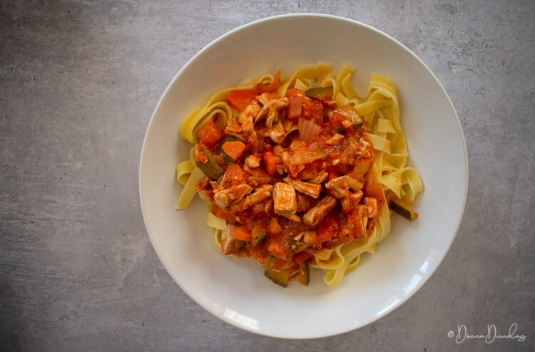 served turkey in tomato sauce with pasta.