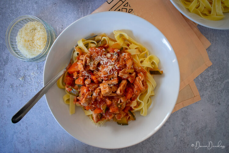 served turkey pasta with parmesan on top.