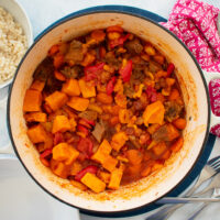Tagine with leftover lamb in cast-iron dish, couscous in bowl to the side.