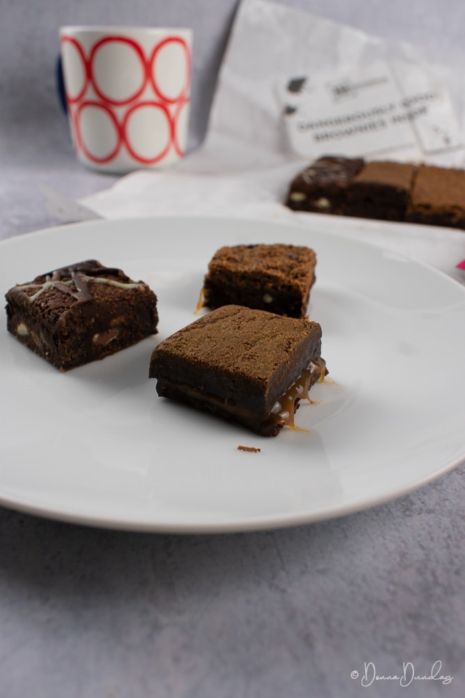 3 brownies on a plate.