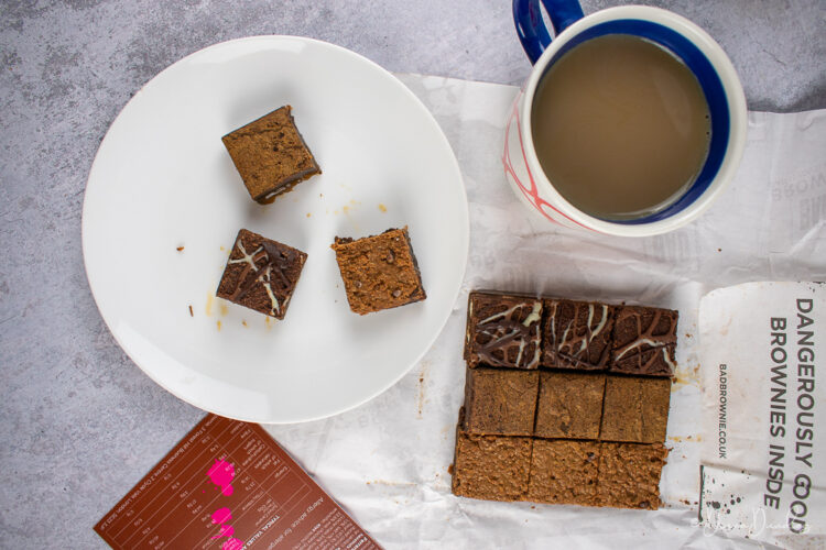 3 brownies on plate, coffee, and brownie squares to the side.
