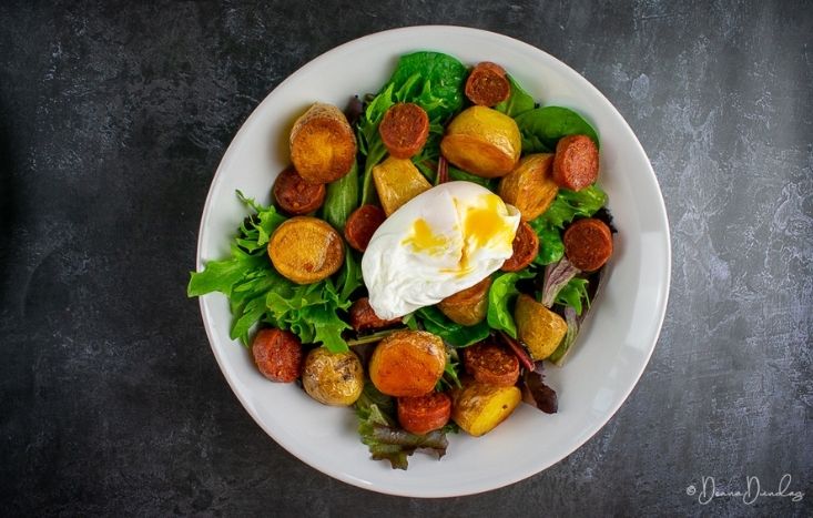 Top view of potato and chorizo salad in bowl.