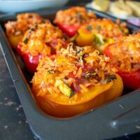 peppers with rice and halloumi on baking tray.