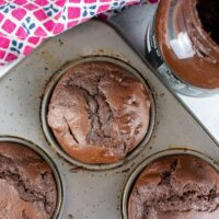 top view of chocolate muffins with nutella in muffin tin.