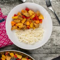 Leftover Roast Pork with Sweet and Sour Sauce served with rice in white pasta bowl.