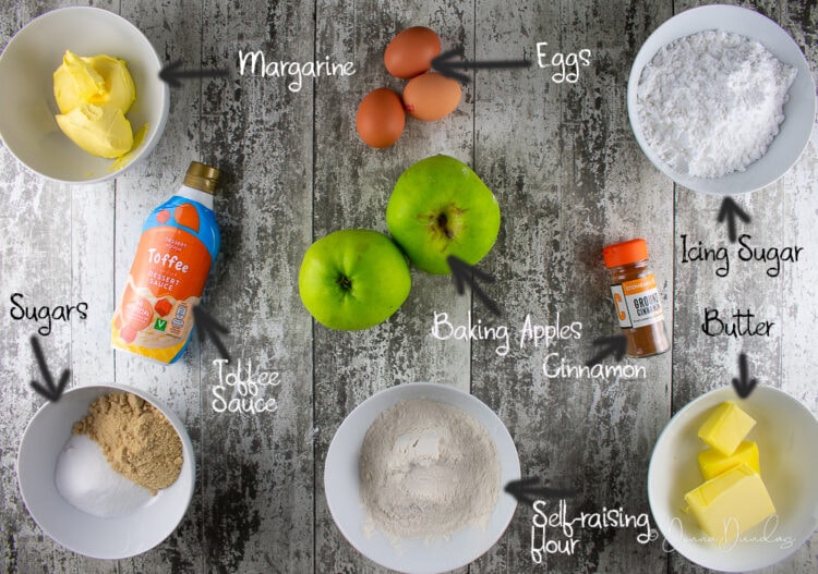 labeled ingredients for toffee apple loaf cake on white wooded table.