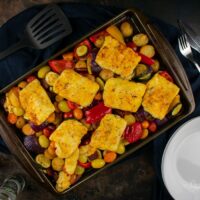 Cooked halloumi and chorizo traybake on baking tray.