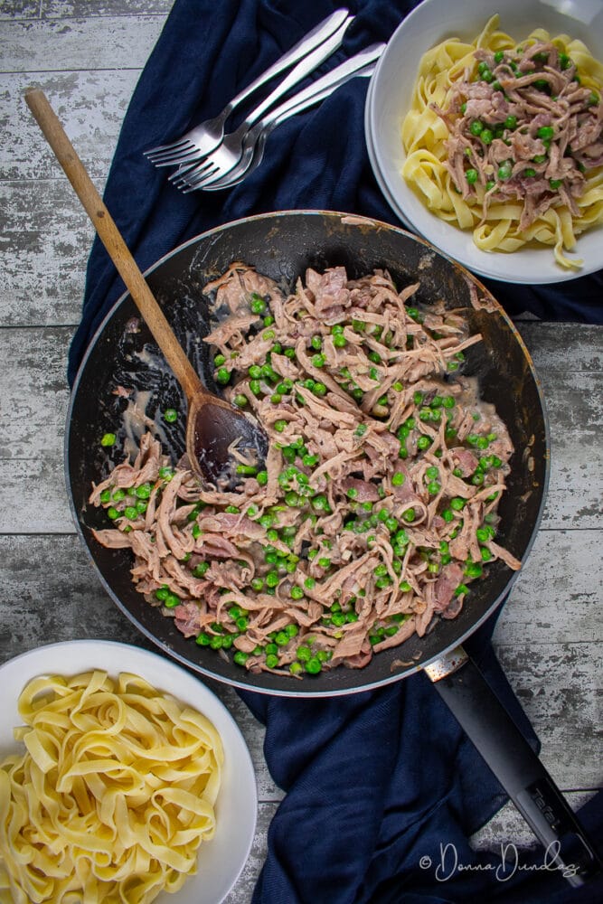 Leftover Turkey Pasta with Cranberry sauce in frying pan, served portion to the side.