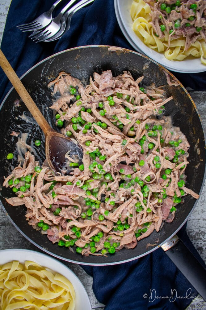 Leftover Turkey Pasta with Cranberry sauce in frying pan, served portion to the side.