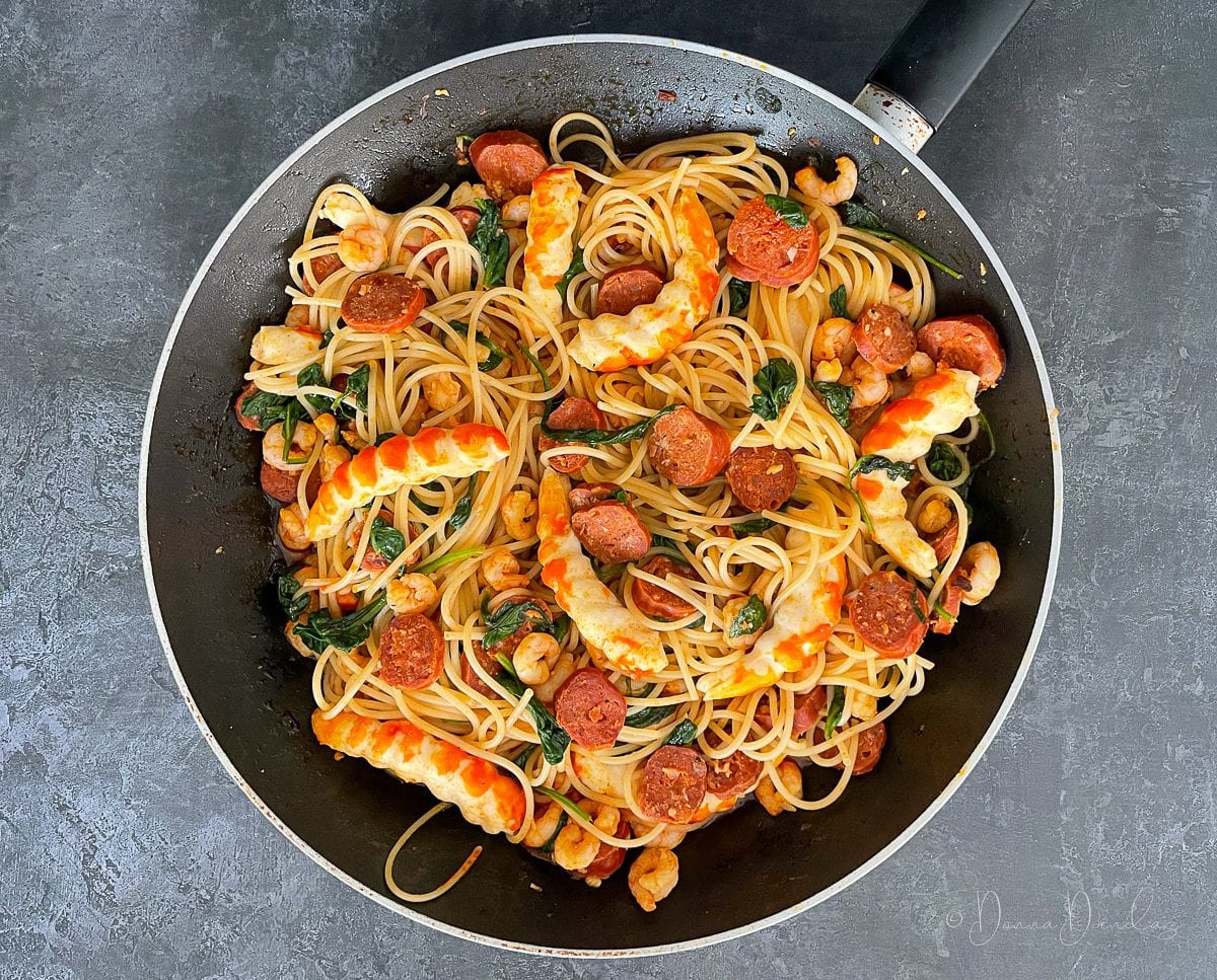prawn and chorizo pasta in frying pan from above.
