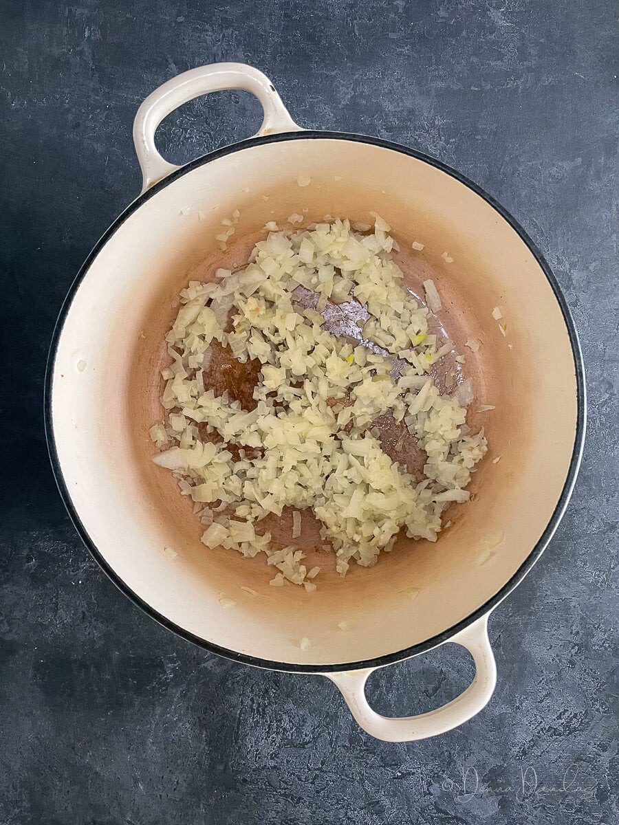 onions frying in cast iron dish.
