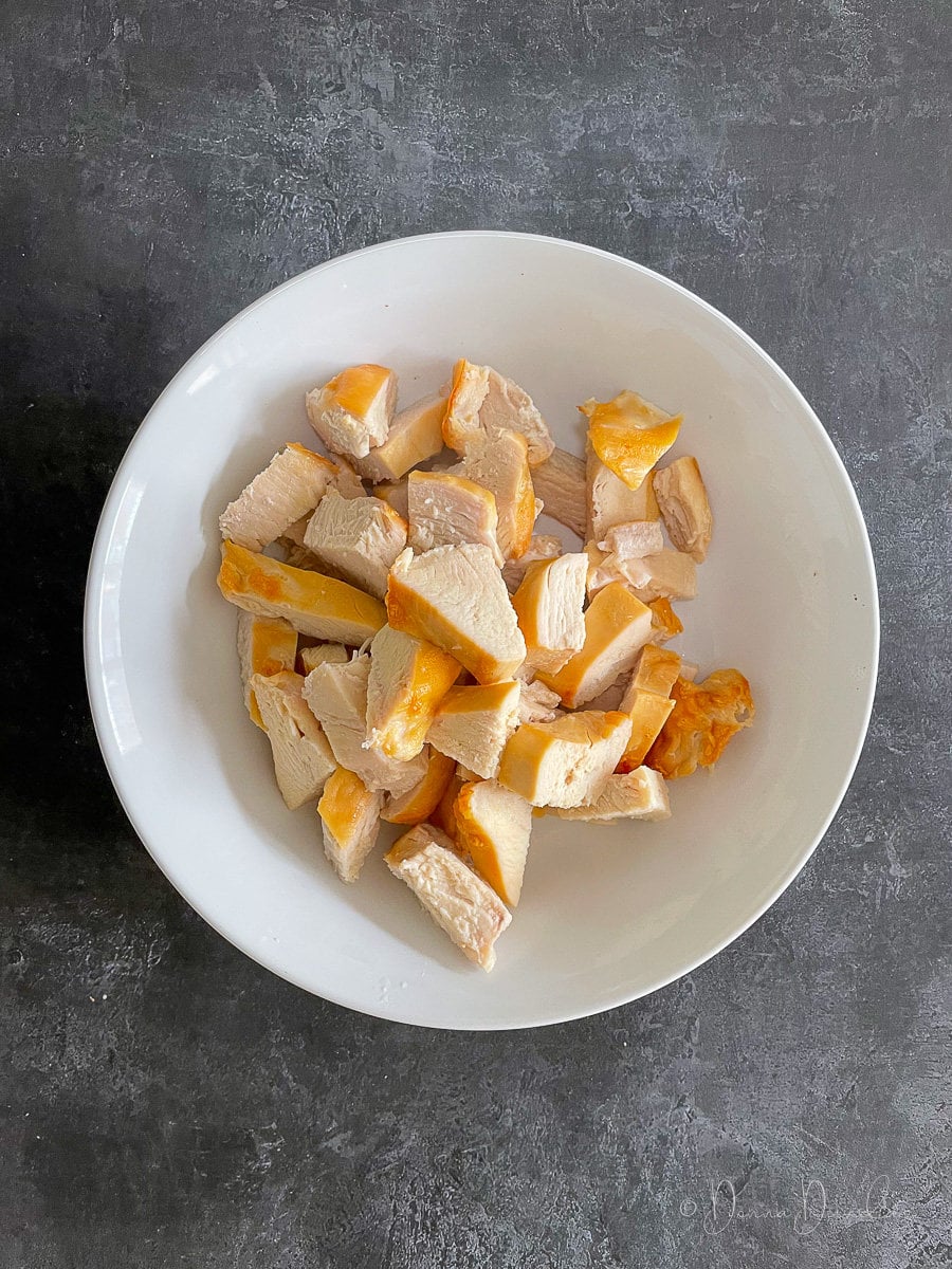 diced cooked chicken breasts in white bowl.