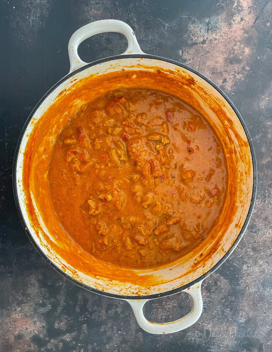 cast iron dish filled with dark orange curry.