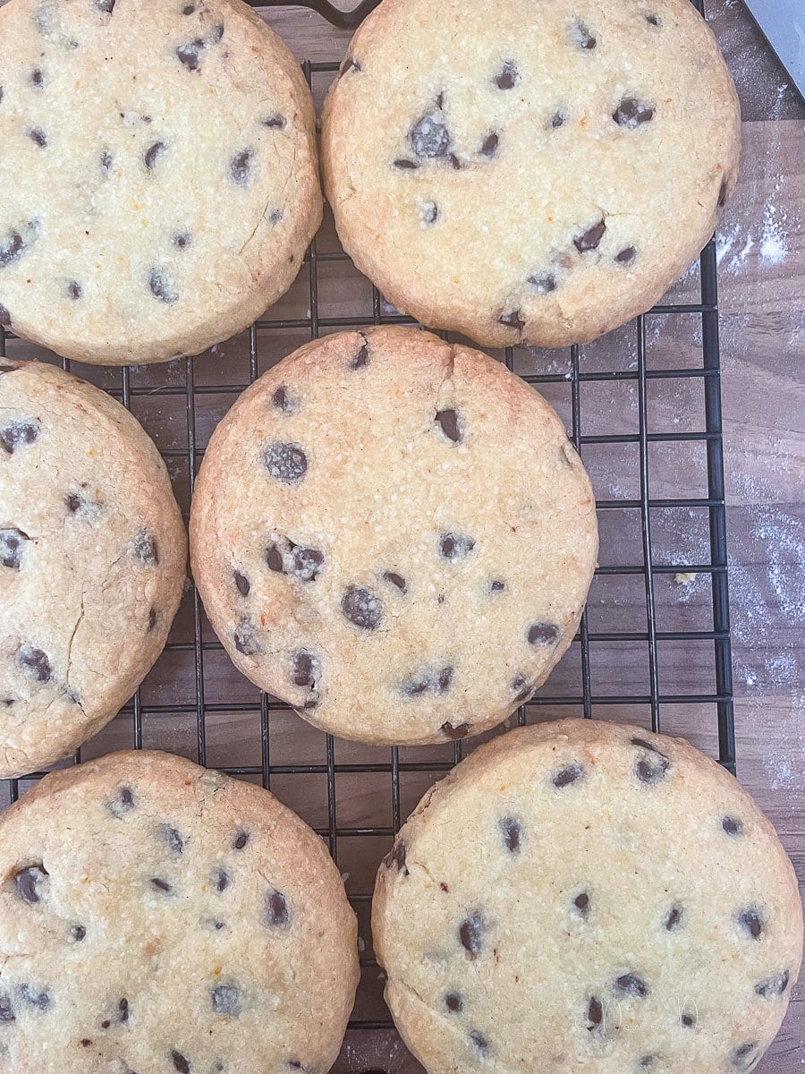 baked cookies with chocolate chips on wire rack.