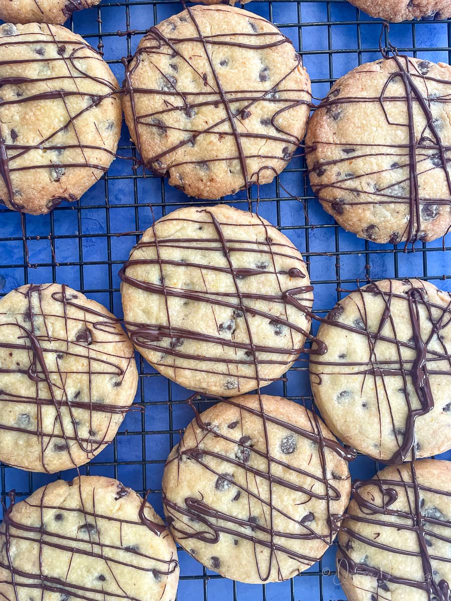 cookies with chocolate drizzle on wire rack.