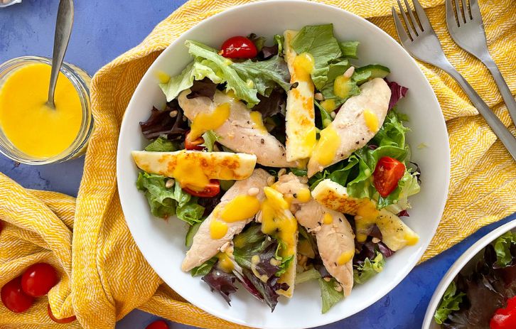 chicken salad topped with mango dressing. Small dish of dressing to the side.