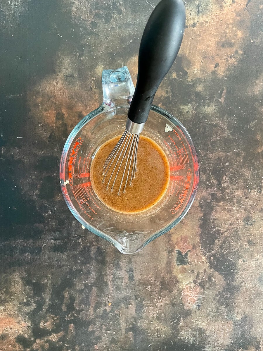 stir fry sauce in glass jug with whisk.