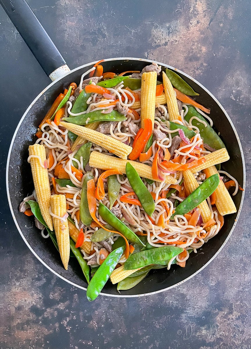 noodles, lamb and veg in pan.