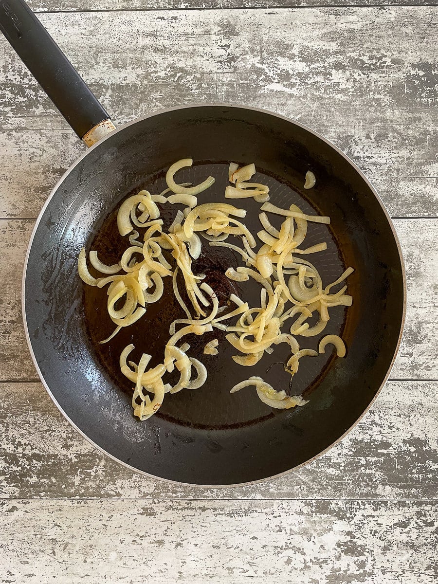 frying onions in pan.