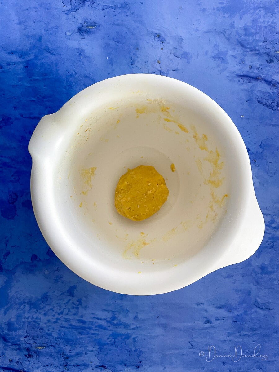 ball or shortbread dough in white mixing bowl.