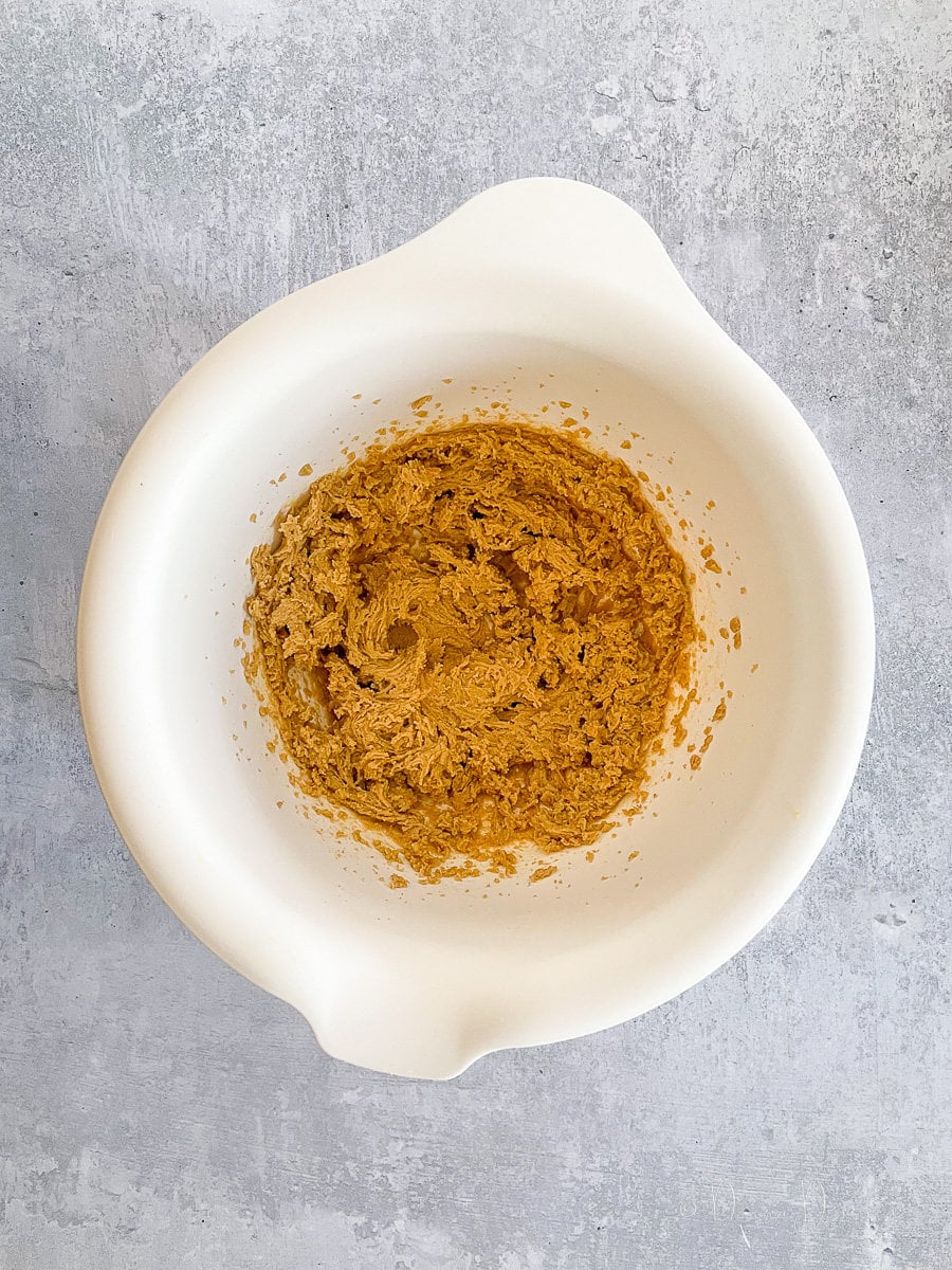 brown sugar and margarine mixed together in white mixing bowl.