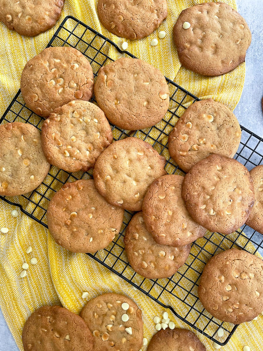 White chocolate chip cookies on wire rack.