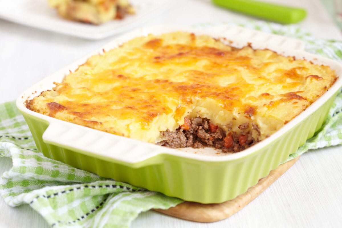 Cottage pie in green baking dish.