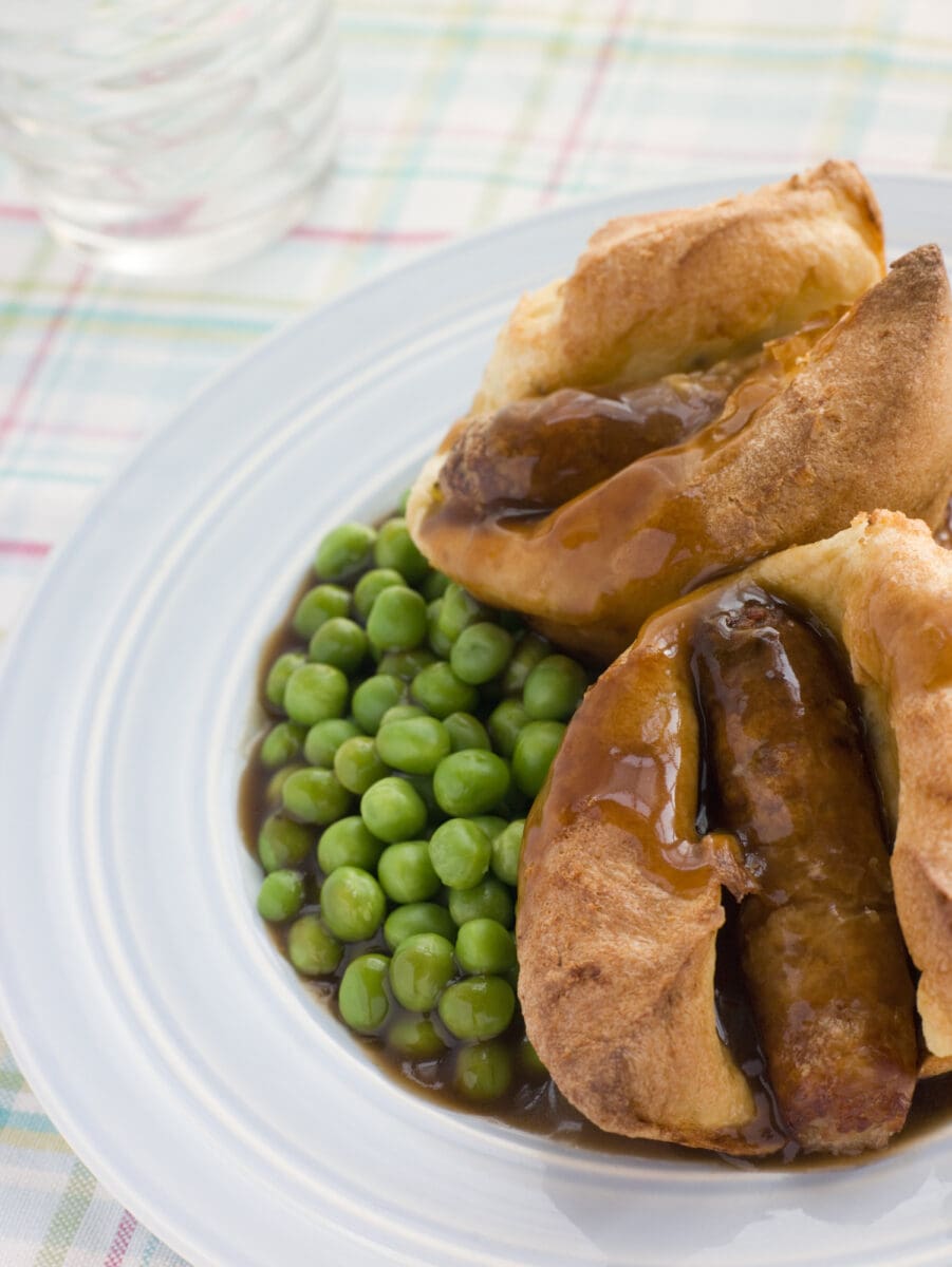 Individual Toad in the Holes with Gravy and Peas.