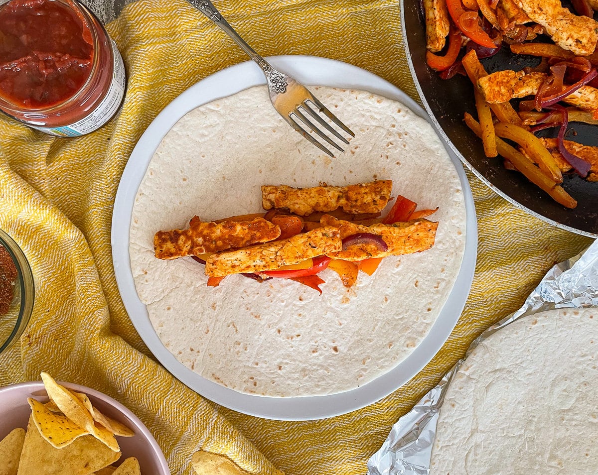 slices of halloumi and peppers on wrap.