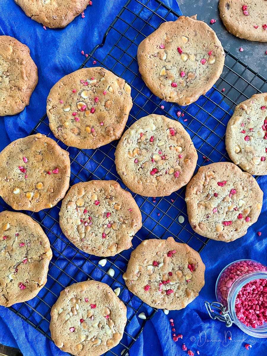 white chocolate and raspberry cookies on wire rack.