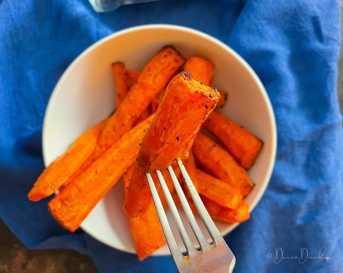 close up of carrot on fork.
