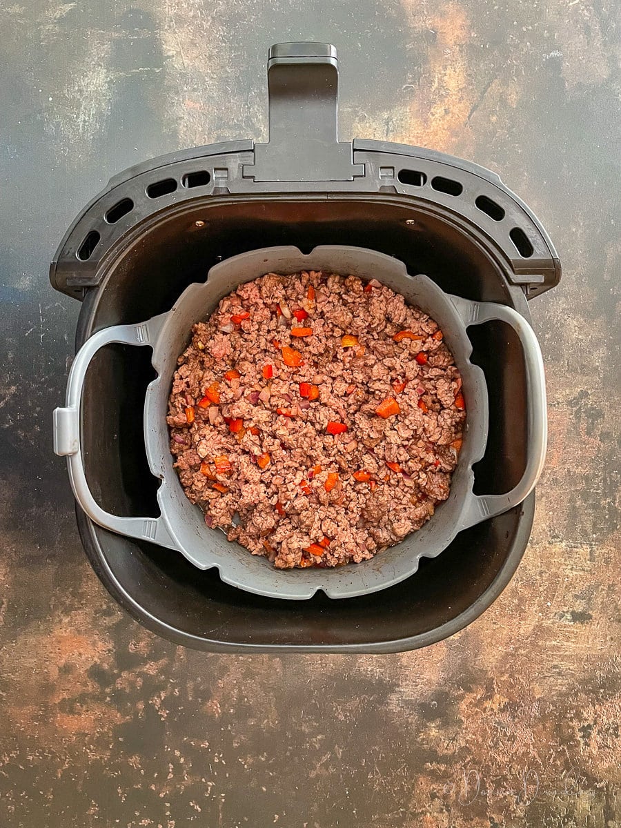 chilli cooking in air fryer drawer.