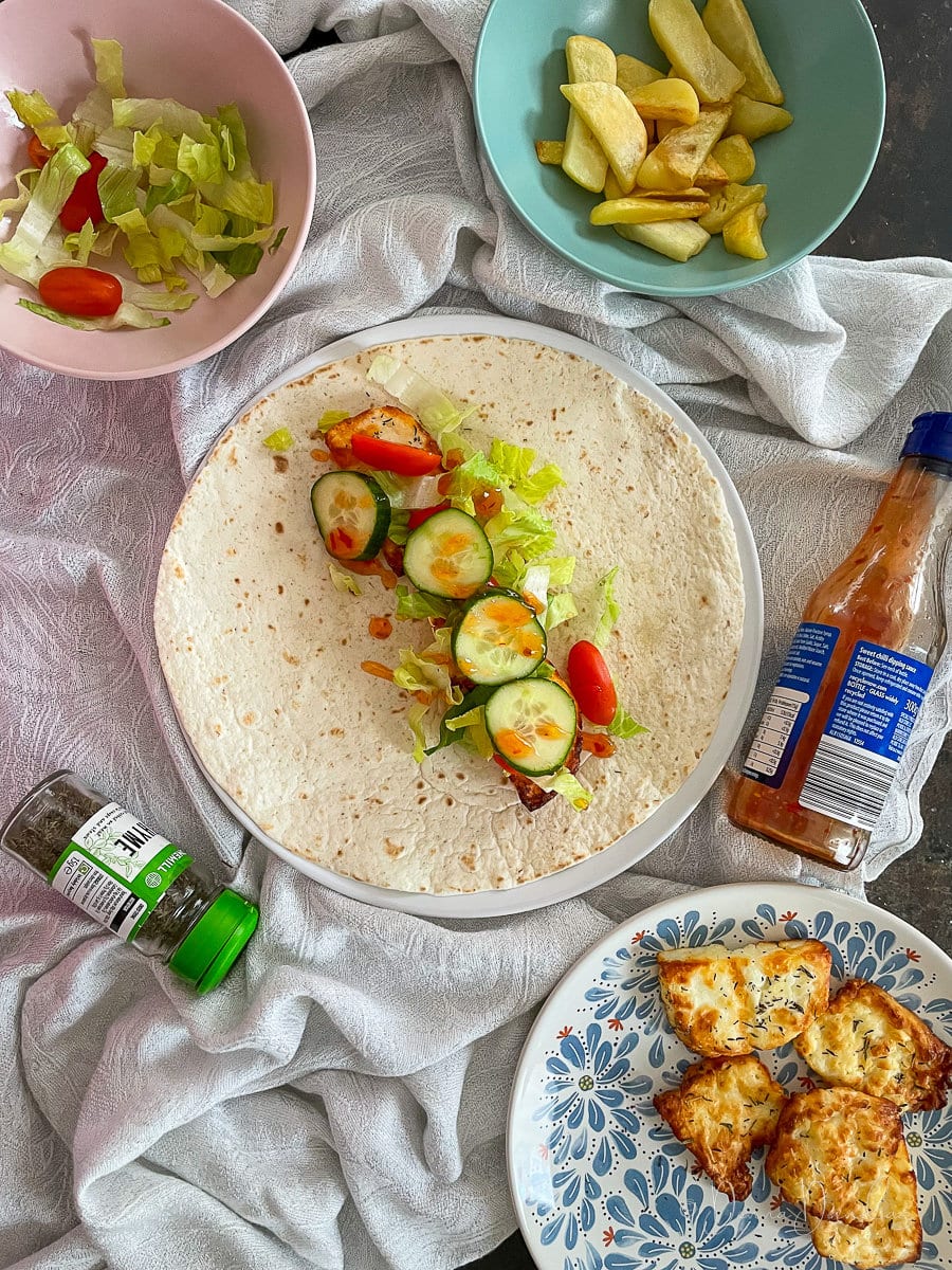 halloumi on a wrap with salad and sweet chilli sauce.