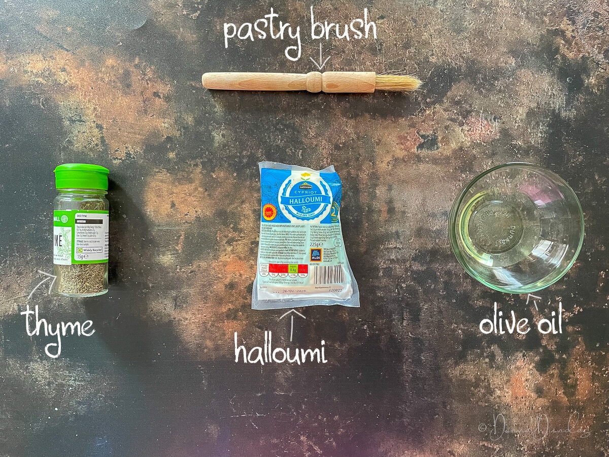 ingredients for air fryer halloumi cheese - thyme, halloumi, oil and a pastry brush.