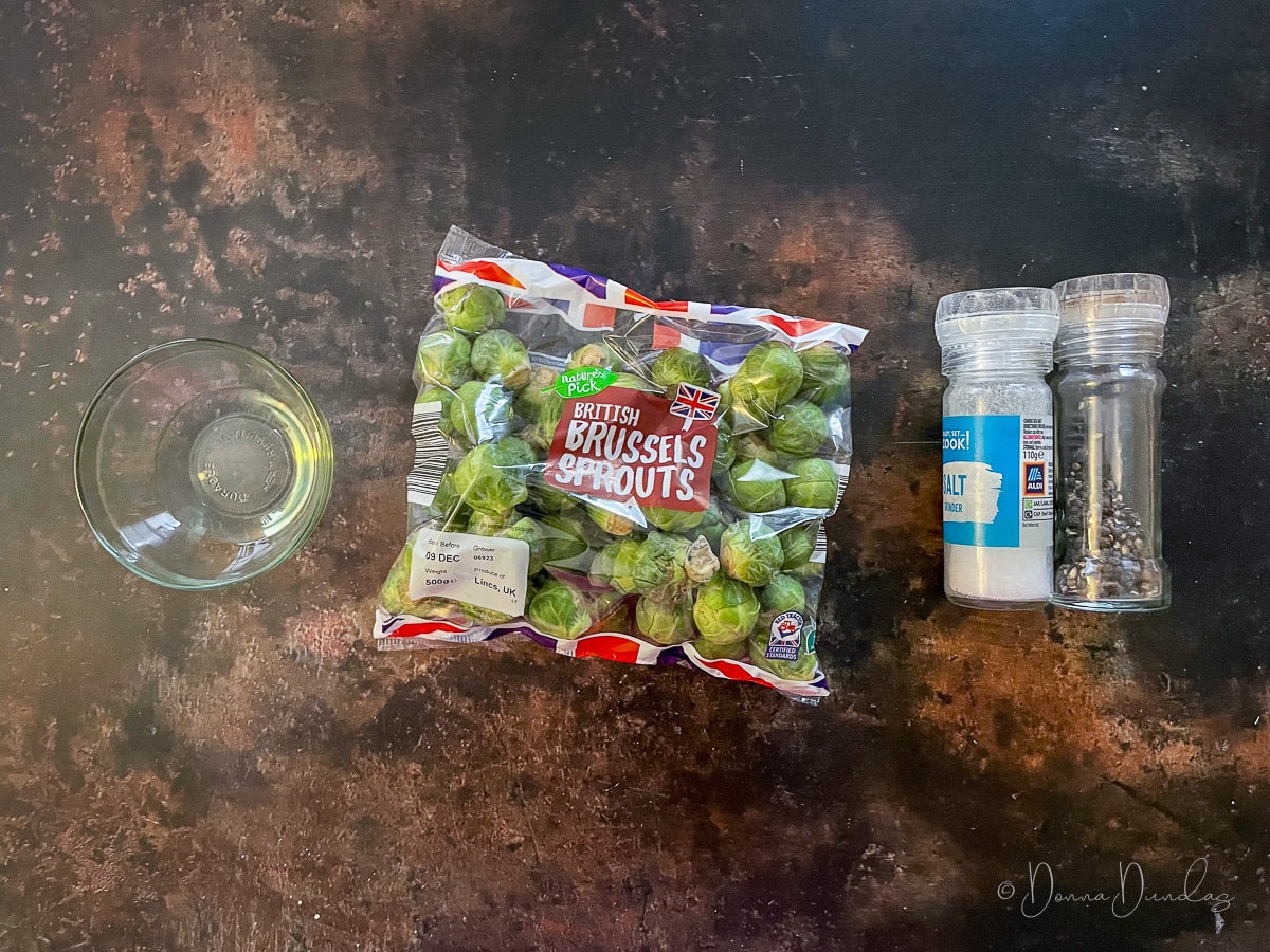 sprouts, oil and salt and pepper on table.