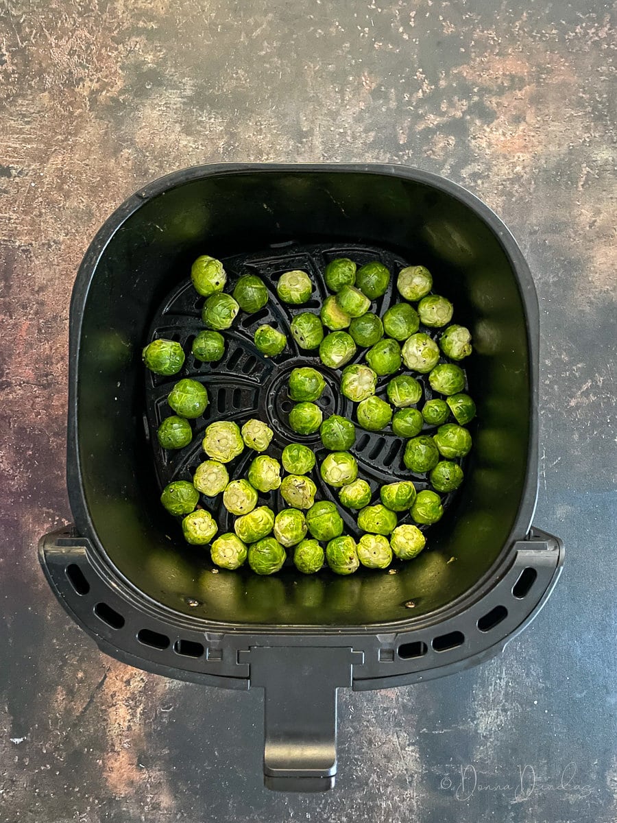 brussels sprouts in air fryer basket.