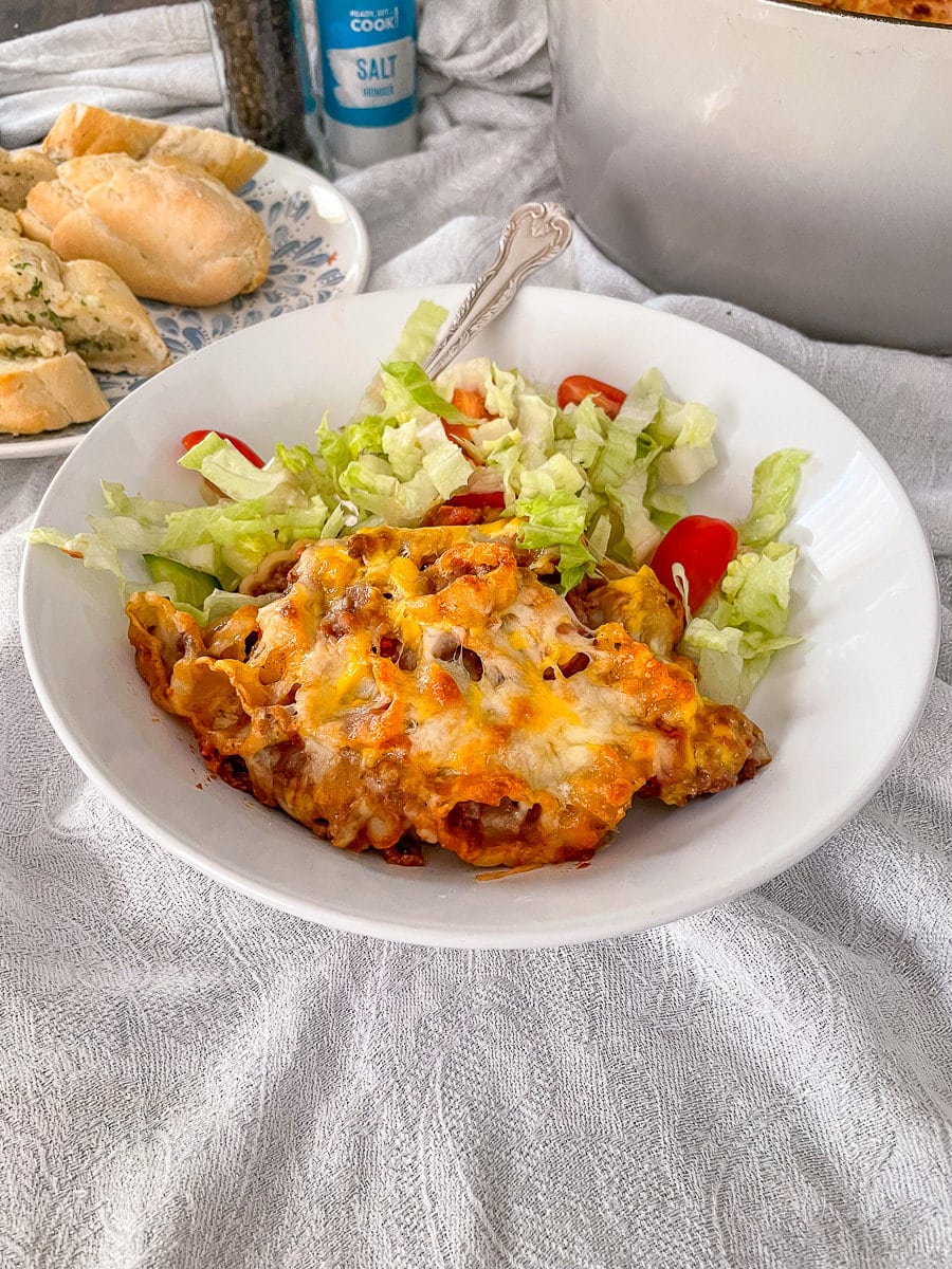 pasta bake served with salad in bowl.